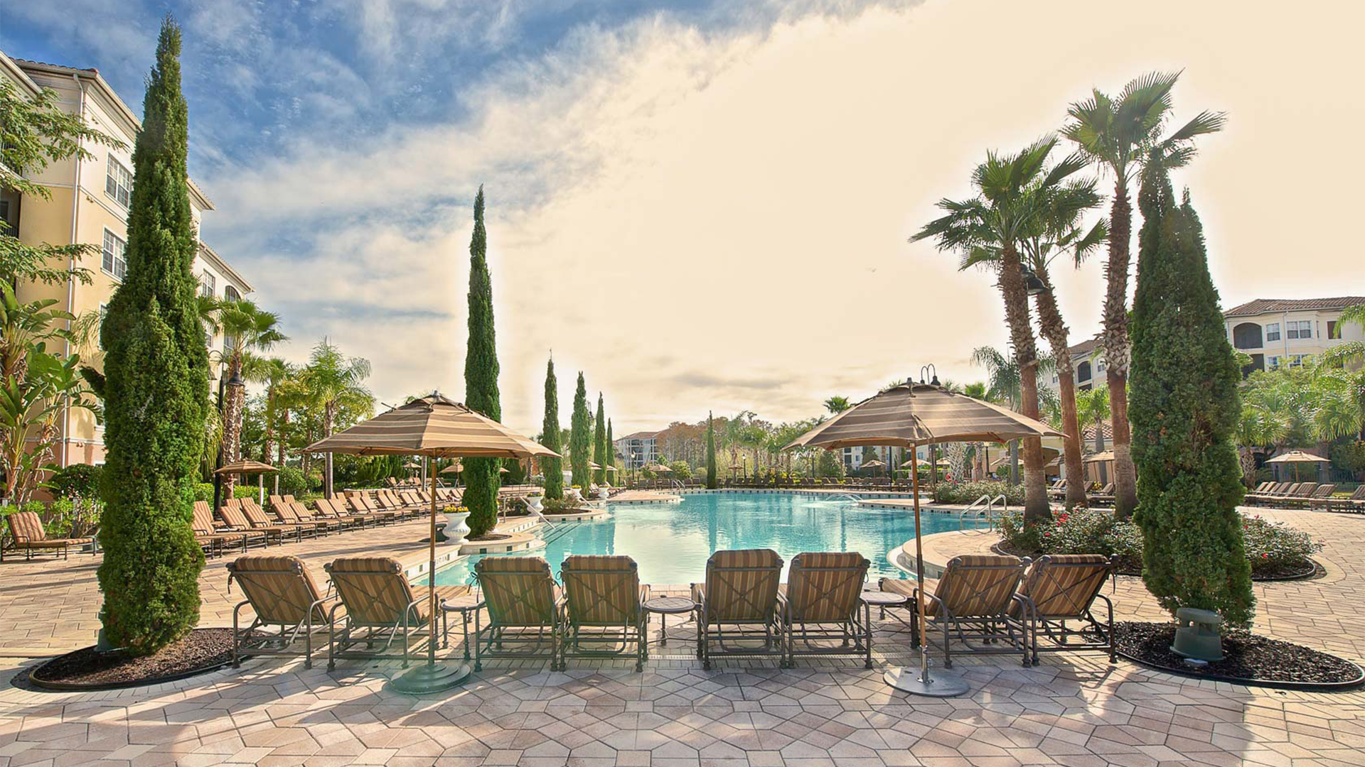 a pool with chairs and umbrellas