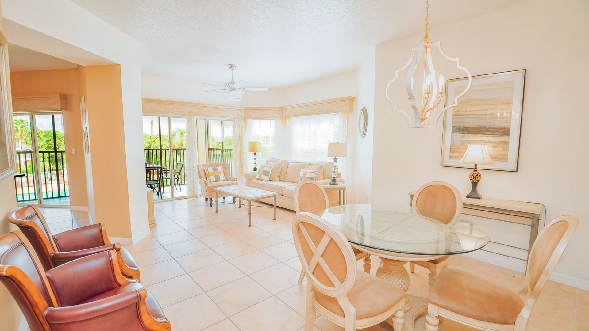 a room with a table chairs and a chandelier